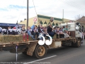 Children from the Merriwa Sports Club waiving to the crowd during the Festival of the Fleeces.