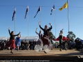 The clans dance united under the flags.