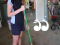 Darcy Pittman helping sweep out the dried mud in Hunt-A-Book following a storm.